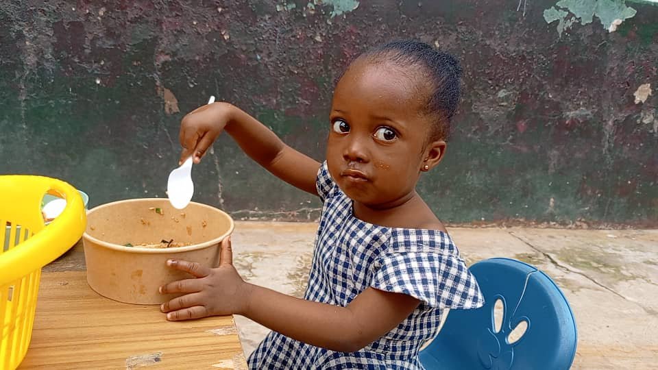 A young child eating a meal at a table