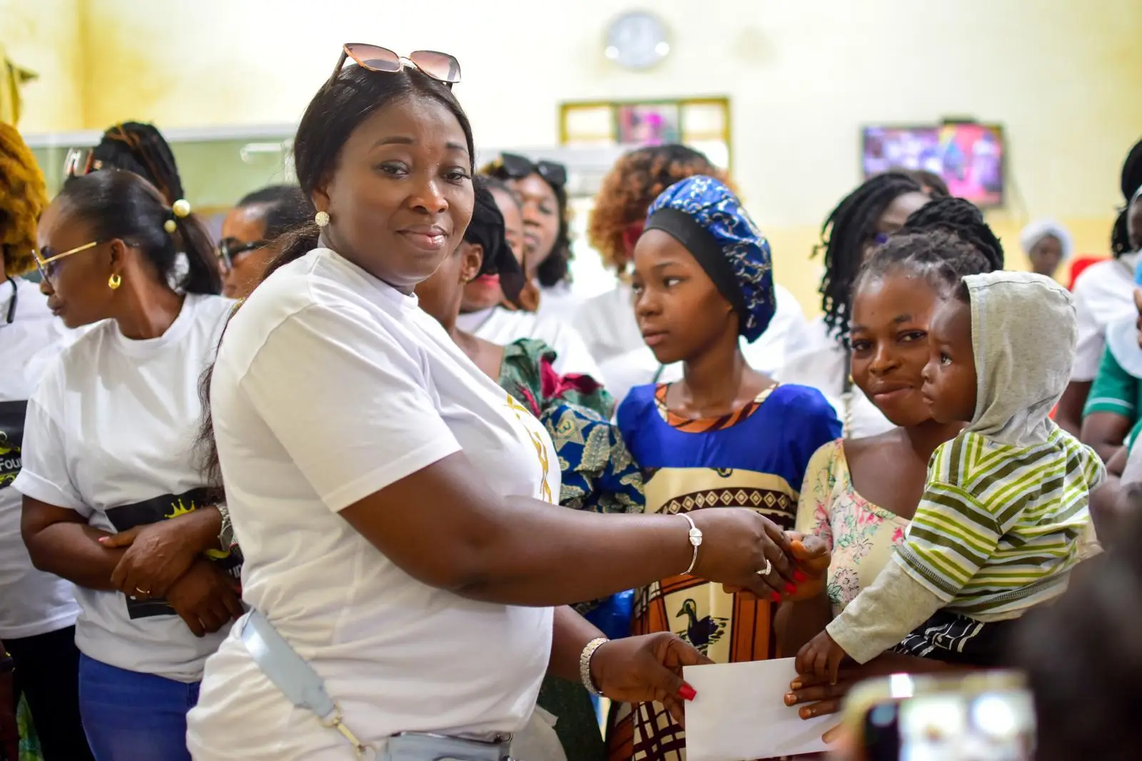 A Ryvanz-Mia Charity representative delivering support to a mother and children
