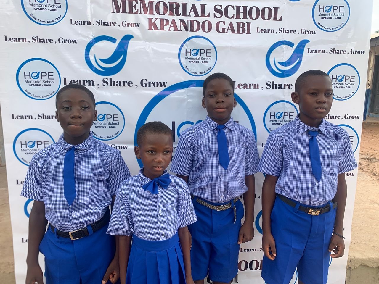 Students and staff gathered outside a school supported by Ryvanz-Mia Charity