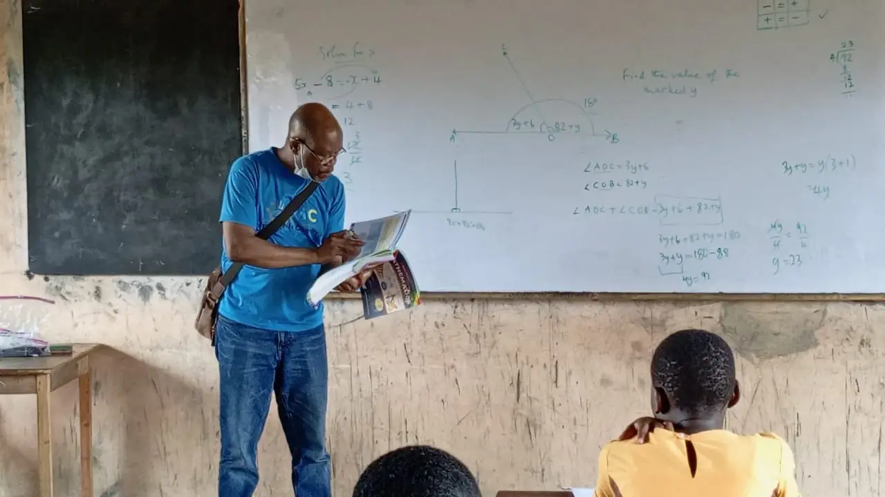 A Ryvanz-Mia Charity director working with children inside a classroom