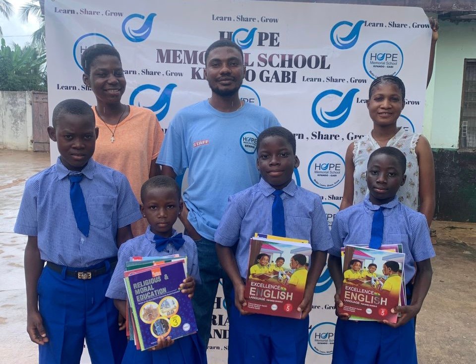 Hope Memorial School students receiving new educational books