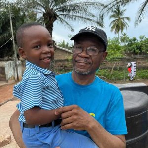 Founder with a child from Hope Memorial School,Kpando Ghana