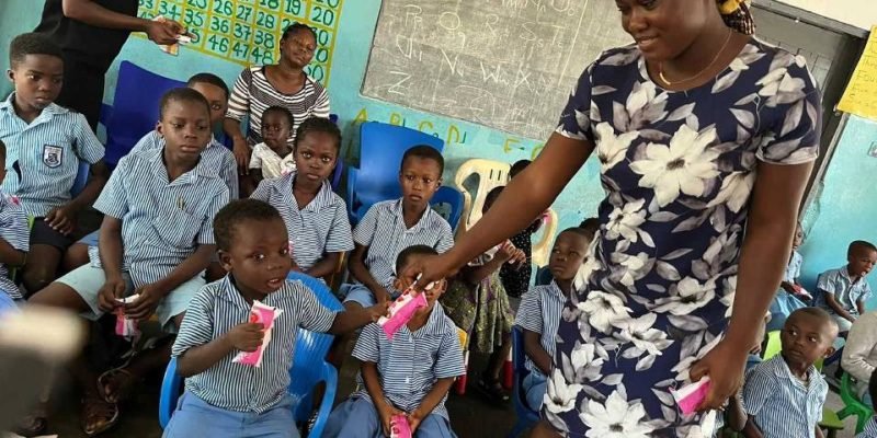 Hope Memorial School teacher sharing gifts to pupils