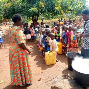 Serving breakfast to children in Kaliro Uganda