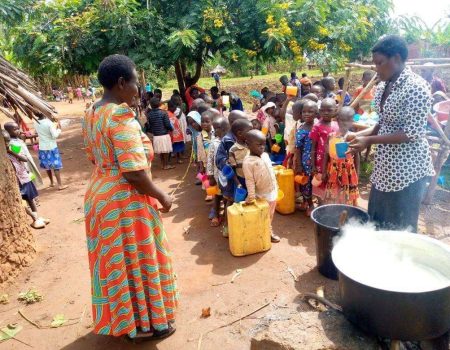 Serving breakfast to children in Kaliro Uganda